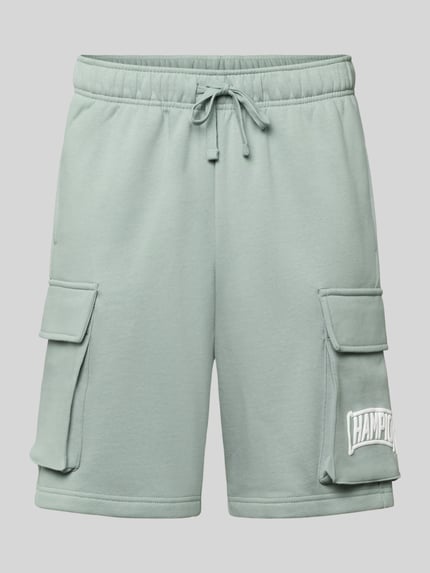 Produktfoto, Sweatshorts mit Cargotaschen und Logo von CHAMPION in Hellgrün, Baumwoll-Mix, Relaxed Fit, elastischer Bund, sichtbare Struktur