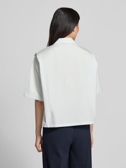 Vrouwenmodel draagt Oversized Hemdbluse uit pure katoen model 'BIMINA' van BOSS, look: effen, oversized fit, overhemdkraag, labeldetail, knoopsluiting, korte mouw, materiaalverwerking: popeline, productfoto in effen lichte kleur, volledig van achteren, Ganzkörperansicht Rückansicht.