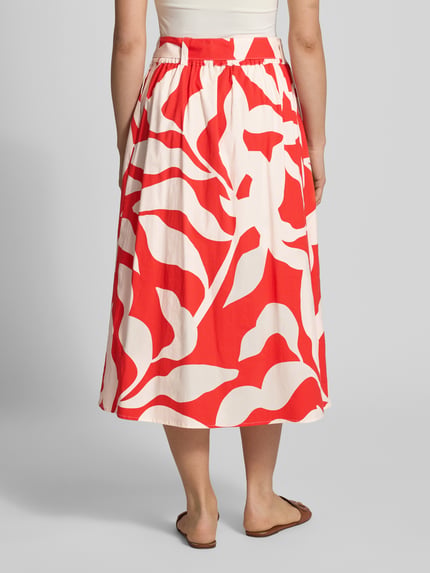 Frauenmodel trägt Regular Fit Midirock mit floralem Allover-Print von More & More in Rot und Weiß, Falten-Optik, Baumwoll-Mix, abnehmbares Taillenband, Ganzkörperansicht Rückansicht.