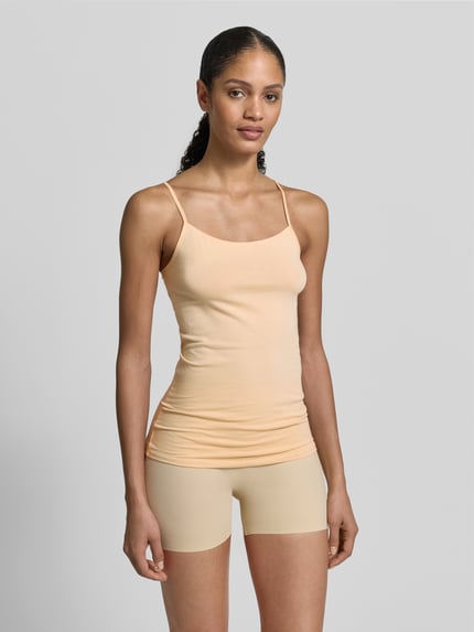 Vrouwenmodel draagt 'Unterhemd mit Spaghettiträgern' van Schiesser, katoen-elastaan mix, slim fit, ronde hals, in perzikkleur, voorkant volledig te zien, vooraanzicht.
