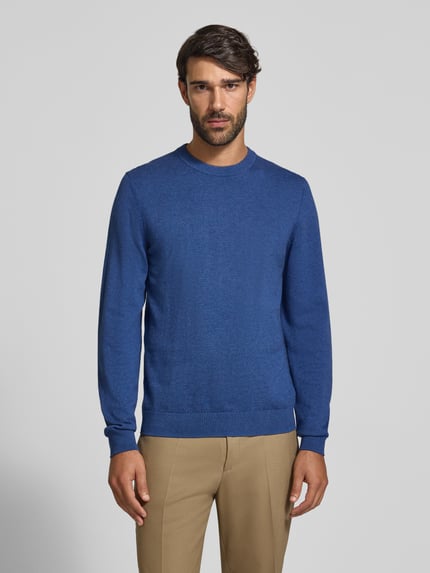 Männermodel trägt Strickpullover aus Baumwoll-Kaschmir-Mix mit Rundhalsausschnitt von MCNEAL in Blau, Regular Fit, Ganzkörperansicht von vorne