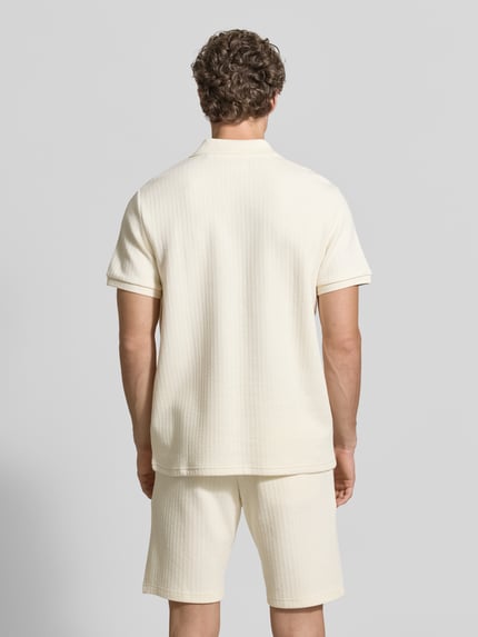 Männermodel trägt Regular Fit Strick-Poloshirt mit V-Ausschnitt von MCNEAL aus Baumwoll-Mix mit Stretch-Anteil, Rückenlänge 70 cm, Ganzkörperansicht Rückansicht.