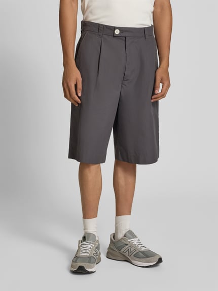 Männermodel trägt Straight Fit Bermuda mit Bundfalten von ANNARR aus Reine Baumwolle, Bundfalten, Gesäßtaschen, Ganzkörperansicht von vorne.
