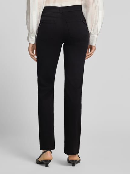 Frauenmodel trägt Straight Fit Stoffhose im 5-Pocket-Design von Christian Berg Woman, schwarze Farbe, Strasssteinbesatz, Ganzkörperansicht Rückansicht, elastischer Baumwoll-Mix mit Viskose-Anteil.