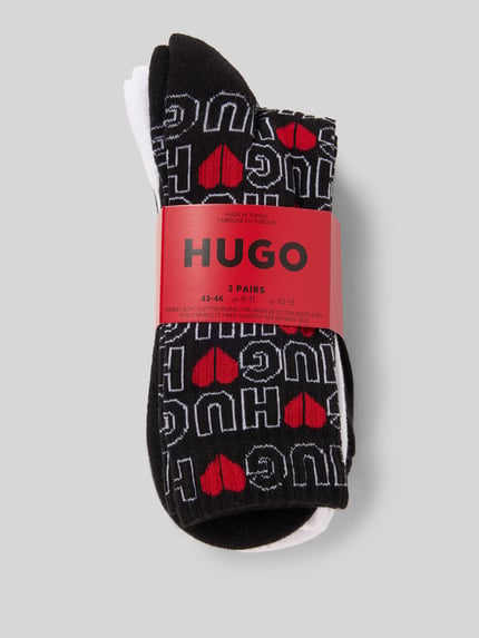 Produktfoto, Socken aus Baumwoll-Mix im 3er-Pack Modell 'VALENTINE' von HUGO, unifarbene und gemusterte Designs, elastischer Bund, Logo-Print, Nahaufnahme.