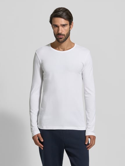 Męski model nosi Longsleeve z prążkowanym okrągłym dekoltem od Schiesser, biały, slim fit, mieszanka bawełny i elastanu, widok z przodu.