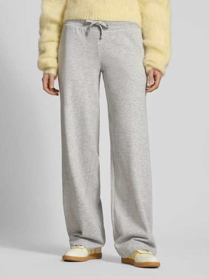Frauenmodel trägt Wide Fit Sweatpants mit Viskose-Anteil von Review, Baumwoll-Mix, elastischer Bund, Tunnelzug, Ganzkörperansicht von vorne.