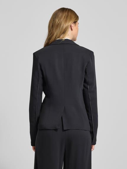 Vrouwenmodel draagt Blazer met Reverskraag Model 'Cecile' van GUIDO MARIA KRETSCHMER WOMAN, mix van viscose en elastaan, nauwsluitende pasvorm, knoopsluiting, klepzakken, ruglengte bij maat 36 is 62 cm, kleur zwart, gladde textuur, Ganzkörperansicht Rückansicht.