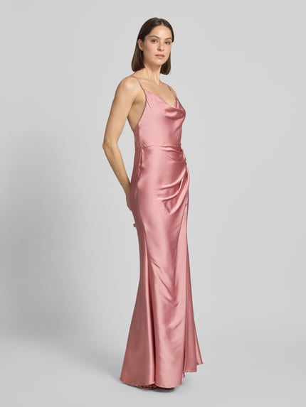 Frauenmodel trägt Slim Fit Abendkleid mit Rückenausschnitt von Laona in rosa Satin mit Raffungen und verstellbaren Spaghettiträgern, Ganzkörperansicht von vorne.