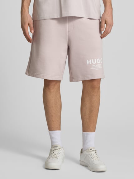 Männermodel trägt Loose Fit Sweatshorts aus reiner Baumwolle Modell 'Nomario' von Hugo Blue, Optik: Unifarben, Sweat, Nahaufnahme Unterkörper.