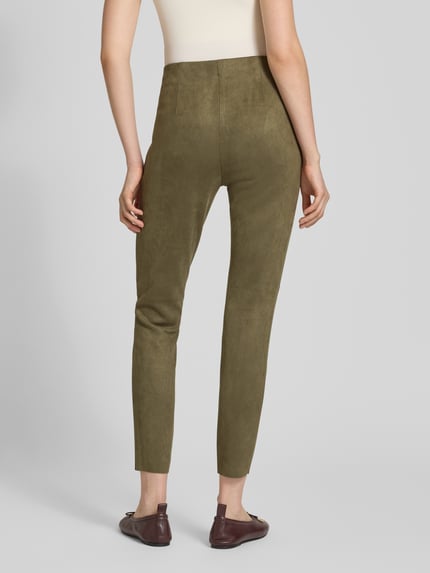 Kobieta nosi Slim Fit Hose in verkürzter Passform od Christian Berg Woman, oliwkowa, welurowa faktura, krój slim fit, widok z tyłu, Szerokość w rozmiarze 36: 37 cm, długość wewnętrzna nogawki 73 cm.