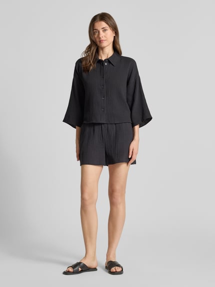 Frauenmodel trägt Loose Fit Hemdbluse aus reiner Baumwolle Modell 'NATALI' von Vero Moda, Optik: Unifarben, Materialverarbeitung: Seersucker, Ganzkörperansicht von vorne.