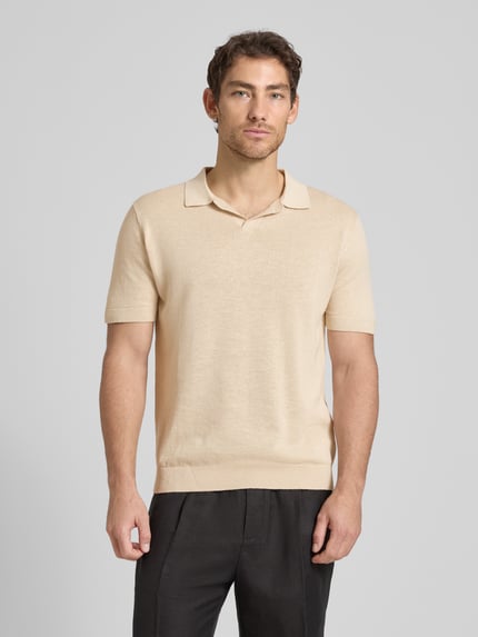 Männermodel trägt Regular Fit Poloshirt aus Baumwoll-Leinen-Mix Modell 'MATTIS' von SELECTED HOMME in Beige, Ganzkörperansicht von vorne. Unifarbenes Feinstrick-Oberteil mit Polokragen, V-Ausschnitt und kurzem Arm, dezenter Label Patch, angenehme Struktur.