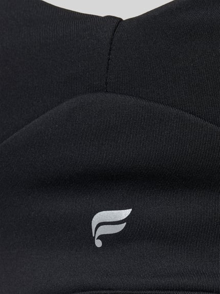Produktfoto, czarny Stanik z nadrukiem z logo PURELUXE LONGLINE od Fabletics, elastyczna mieszanka materiałów, typ Low Impact