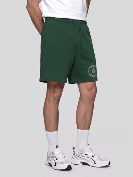 Mężczyznamodel nosi Regular Fit Sweatshorts aus Baumwoll-Mix od Nike, zielony materiał, proste nogawki, gładka faktura, Ganzkörperansicht z przodu.