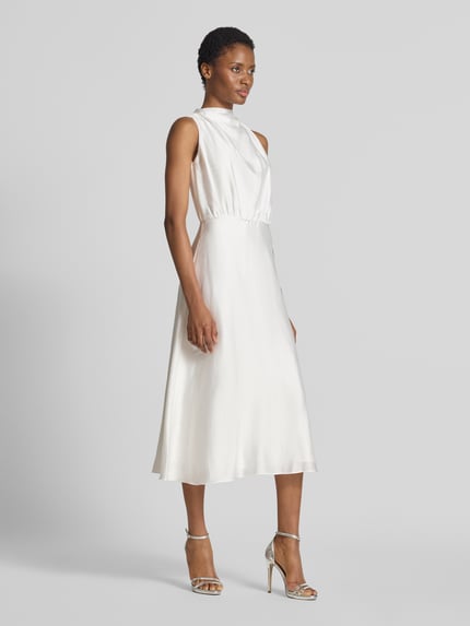 Frauenmodel trägt Midikleid aus Satin mit Stehkragen von SWING in Creme, taillierte Passform, ärmellos, Falten-Optik, Ganzkörperansicht von vorne.