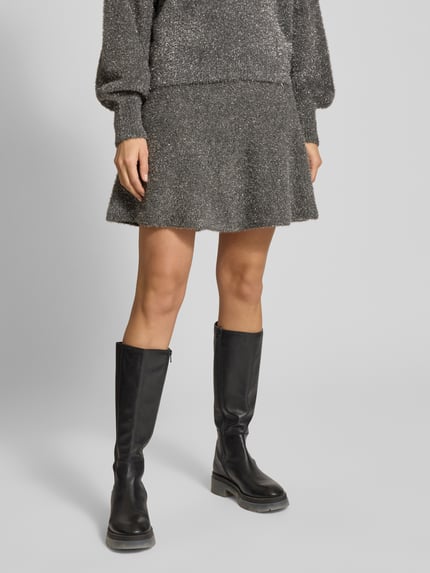 Frauenmodel trägt Minirock mit elastischem Bund Modell 'LISTRA' von YAS, grau meliert, lockerer Schnitt, Material-Mix, Nahaufnahme Unterkörper.