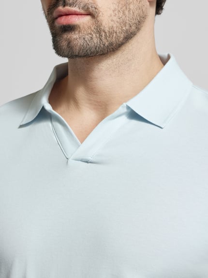 Männermodel trägt Slim Fit Poloshirt mit V-Ausschnitt von Lindbergh, Baumwoll-Elasthan-Mix, hellblau, Nahaufnahme Oberkörper. Rückenlänge bei Größe M: 68 cm.