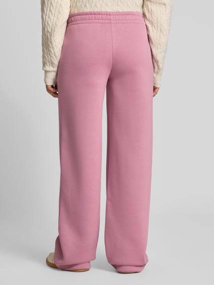 Frauenmodel trägt Straight Fit Sweatpants aus Baumwoll-Mix mit Label-Detail von REVIEW in Rosa, elastischer Bund, Ganzkörperansicht Rückansicht.
