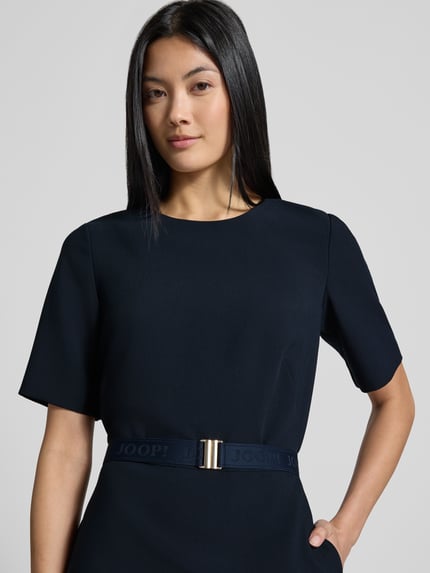 Vrouwenmodel draagt knielange kokerjurk met elastische label in band-riem van JOOP! in effen donkerblauw, nahaufnahme bovenlichaam, Dames Etuikleid von JOOP!