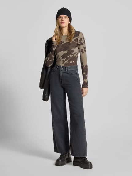 Frauenmodel trägt Longsleeve mit geripptem Rundhalsausschnitt von G-Star Raw in Beige mit braunem Camouflage-Muster, körpernaher Schnitt, Ganzkörperansicht von vorne.