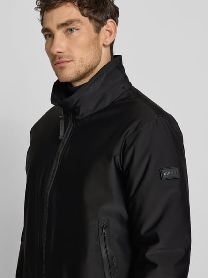 Männermodel trägt Bomberjacke mit Stehkragen Modell 'Ginster' von khujo in Schwarz, glatte Struktur, Regular Fit, Nahaufnahme Oberkörper.