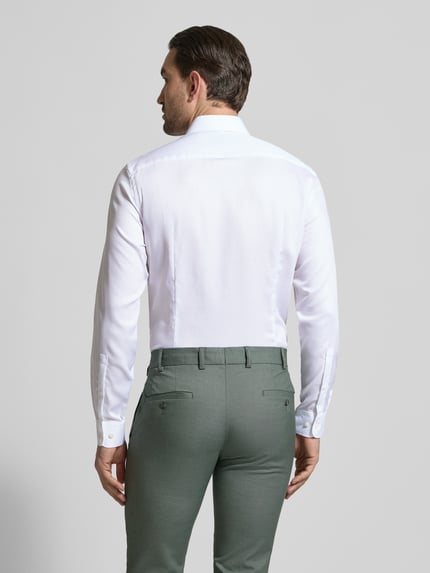 Männermodel trägt Slim Fit Business-Hemd mit Strukturmuster und Kentkragen von Jake*s aus reiner Baumwolle, Ganzkörperansicht Rückansicht. Rückenlänge 70 cm, Schulterbreite 45 cm, Ärmellänge 68 cm, Farbe Weiß, feine Struktur, glatte Textur.
