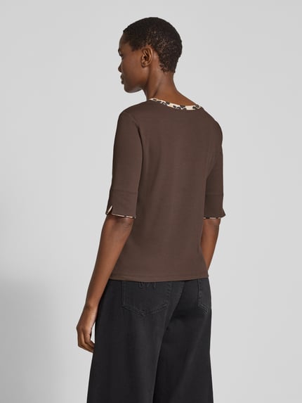 Frauenmodel trägt T-Shirt mit kontrastierendem Ausschnitt von MARC CAIN, unifarbenes Jersey mit Animal Print am Rundhalsausschnitt, geschlitzter Saum, Ganzkörperansicht Rückansicht.