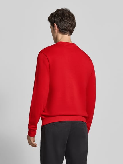 Männermodel trägt Sweatshirt mit Label-Stitching Modell 'BALIS' van Napapijri in rood, katoen, regular fit, rugaanzicht, context: heren sweatshirt, ronde hals, ruglengte maat M 68 cm, mouwlengte maat M 69 cm.