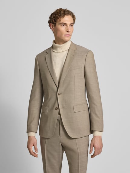 Männermodel trägt Slim Fit Anzug aus Schurwoll-Mix Modell 'H-HUGE-2Pcs-253' von BOSS in Unifarben, Ganzkörperansicht von vorne.