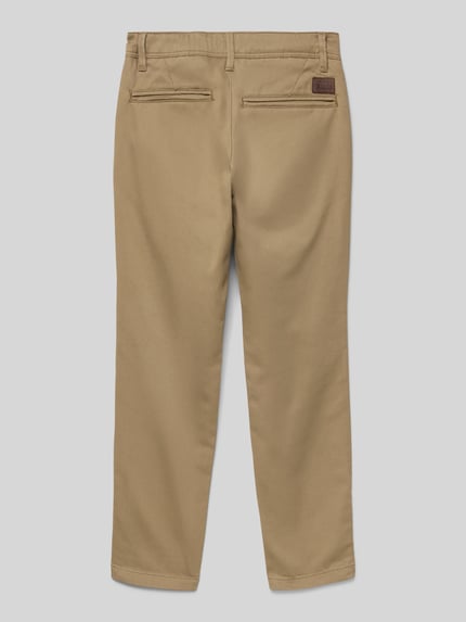 Produktfoto, Spodnie materiałowe z mieszanki bawełny i elastanu od Jack & Jones, prosty krój, tylne kieszenie, detal z logo, kolor beżowy.