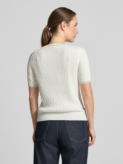 Vrouwenmodel draagt Regular fit pullover uit katoenmix van Lacoste voor dames in gebroken wit met kabelpatroon, volledige rugaanzicht.