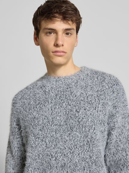 Männermodel trägt Regular Fit Strickpullover mit Alpaka-Anteil Modell 'NOAH' von Only & Sons, Melange-Optik, Nahaufnahme Oberkörper.