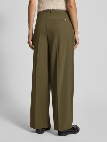 Frauenmodel trägt Stoffhose mit Bundfalten Modell 'Charlize' von MOS MOSH im Material-Mix mit Stretch-Anteil, lockerer Schnitt, Gesäßtasche, Bundweite 32 cm bei Größe 36, Innenbeinlänge 77 cm, Ganzkörperansicht Rückansicht.