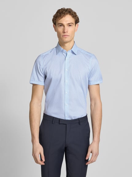 Männermodel trägt Slim Fit Business-Hemd im Allover-Look mit Kentkragen von OLYMP Level Five in hellblau, Baumwoll-Elasthan-Mix, Ganzkörperansicht von vorne.