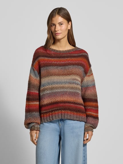 Frauenmodel trägt Strickpullover im Allover-Look Modell 'Strickpullover im Allover-Look Modell 'Fairehaven'' von LOLLYS LAUNDRY, Baumwoll-Mix, Relaxed Fit, Rundhalsausschnitt, Rückenlänge 54 cm, Ärmellänge 58 cm, bunte Streifen in Braun-, Rot- und Beigetönen, grobe Stricktextur, Ganzkörperansicht von vorne.