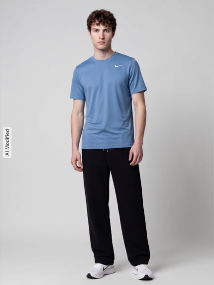 Männermodel trägt Regular Fit Sport-T-Shirt mit Logo-Print von Nike in Blau, kombiniert mit schwarzer Hose, Ganzkörperansicht von vorne, KI-modifiziertes Bild. Herren Sport-T-Shirt von Nike Training