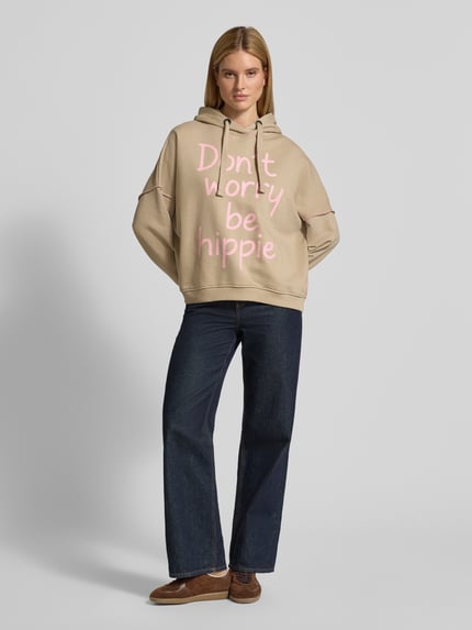 Vrouwenmodel draagt Oversized Hoodie mit Statement-Print van miss goodlife, katoen, oversized pasvorm, beige, roze print, vooraanzicht volledig.