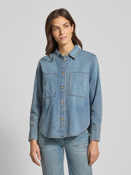 Frauenmodel trägt Hemdbluse in Denim-Optik Modell 'Zutie' von Someday aus reiner Baumwolle mit Hemdblusenkragen und Brusttaschen, lockerer Schnitt, Ganzkörperansicht von vorne.