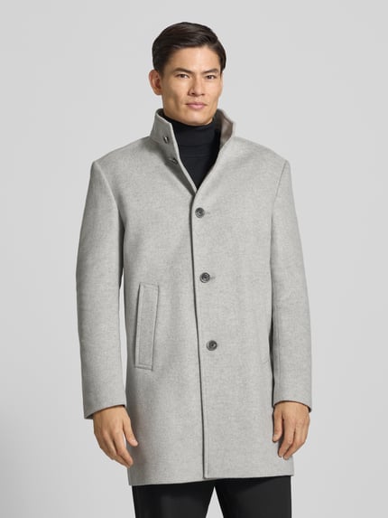 Männermodel trägt Mantel mit hohem Stehkragen Modell 'MARAN' von JOOP!, einfarbig grau, Regular Fit, Knopfverschluss, Ganzkörperansicht von vorne.
