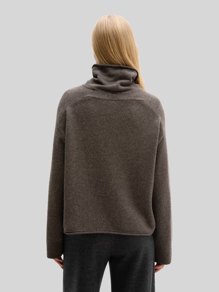 Frauenmodel trägt Rollkragenpullover mit überschnittenen Schultern von MARC O'POLO, unifarben, Strukturstrick, Regular Fit, gerippte Abschlüsse, Ganzkörperansicht Rückansicht.