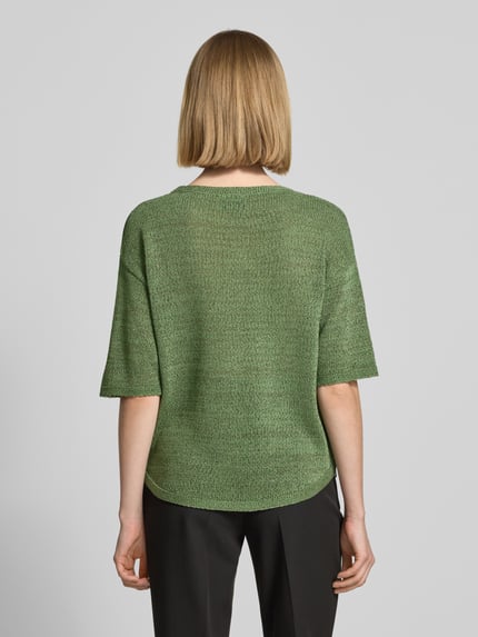 Frauenmodel trägt Relaxed Fit Pullover mit U-Boot-Ausschnitt von s.Oliver BLACK LABEL in schimmernder Optik, Strick, Label-Patch, Ganzkörperansicht Rückansicht.