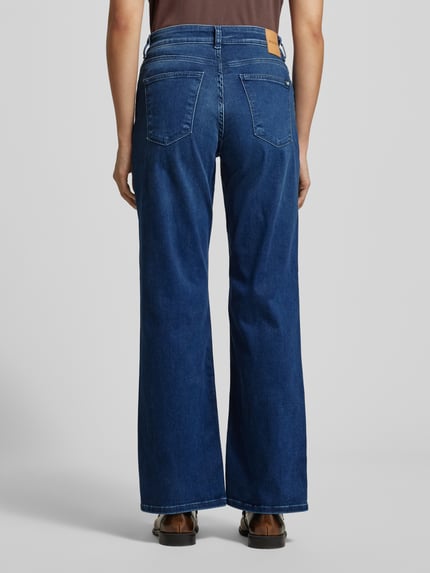 Frauenmodel trägt Loose Fit Jeans mit 5-Pocket-Design Modell 'Madison' von Mustang, blauer Baumwoll-Lyocell-Mix, lockerer Schnitt, Ganzkörperansicht Rückansicht.