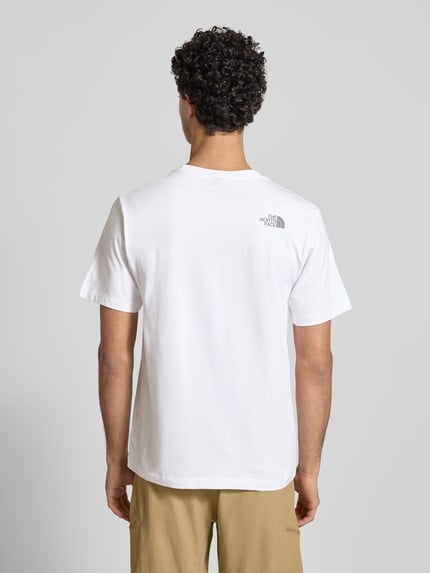Männermodel draagt Regular Fit T-shirt uit puur katoen Model 'MOUNTAIN LINE' van The North Face met labelprint, ronde hals, ruglengte maat M 70 cm, volledig witte kleur, Ganzkörperansicht Rückansicht.