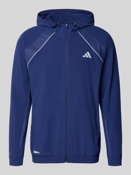 Produktfoto, Regular Fit Kurtka treningowa z nadrukiem z logo model 'Tech' od adidas Training, elastyczna mieszanka materiałów, kaptur z tunelem, kieszeń kangurka, zamek błyskawiczny, kolor ciemnoniebieski, wykończenia elastyczne, długość tyłu 70 cm, długość rękawa 62 cm, styl kurtki treningowej.
