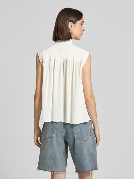 Frauenmodel trägt Blusentop mit Rüschenkragen Modell 'RADIA' von Soyaconcept aus Reine Viskose, Straight Fit, Rückenlänge 62 cm, Ganzkörperansicht Rückansicht.