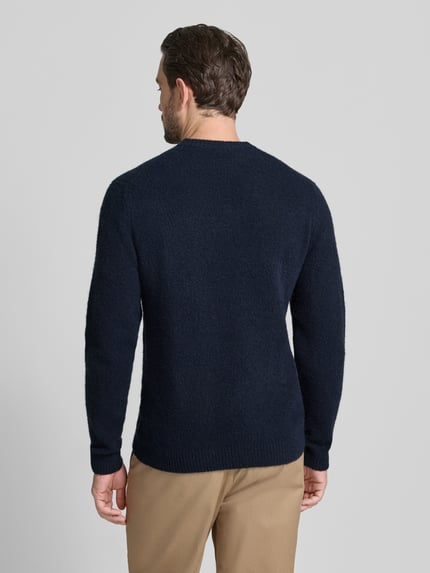 Męski model nosi Sweter z dzianiny z mieszanką wełny Jack & Jones Premium, luźny krój, prążkowane wykończenia, model 'BLASIMON', ciemnoniebieski, okrągły dekolt, długość tyłu 64 cm, długość rękawa 69 cm, widok całej sylwetki z tyłu.