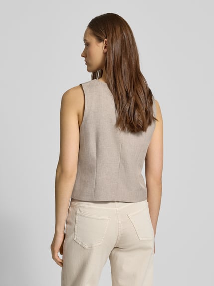 Frauenmodel trägt Regular Fit Weste mit einreihiger Knopfleiste Modell 'LINDA' von ONLY, Melange-Optik, Ganzkörperansicht Rückansicht.
