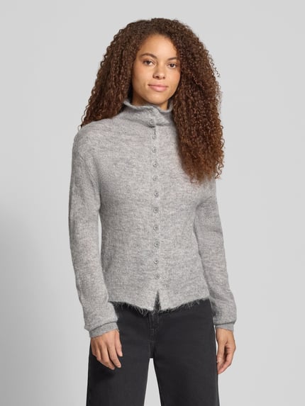 Vrouwenmodel draagt grijze cardigan met alpaca-aandeel en opstaande kraag van Gina Tricot, materiaalmix, nauwsluitend model, knoopsluiting, ruglengte maat S 57 cm, mouwlengte maat S 72 cm, vooraanzicht bovenlichaam