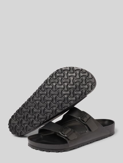 Produktfoto, czarne klapki Slides mit Label-Detail Modell 'ARIZONA EVA' von Birkenstock, zaokrąglony kształt, sprzączka, fakturowana podeszwa, wysokość obcasa: 4 cm w rozmiarze 45